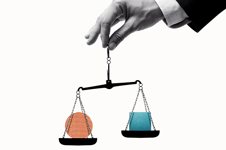 Hand balancing scales with geometric shapes